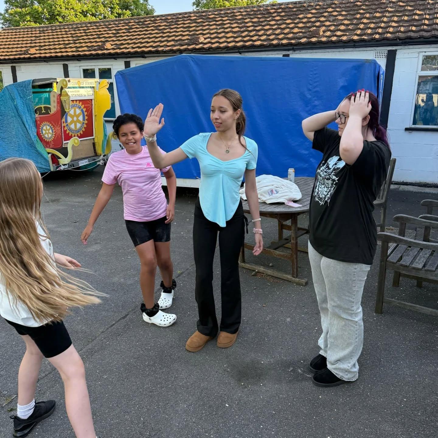 Young people gathered around a table activity at the youth club.